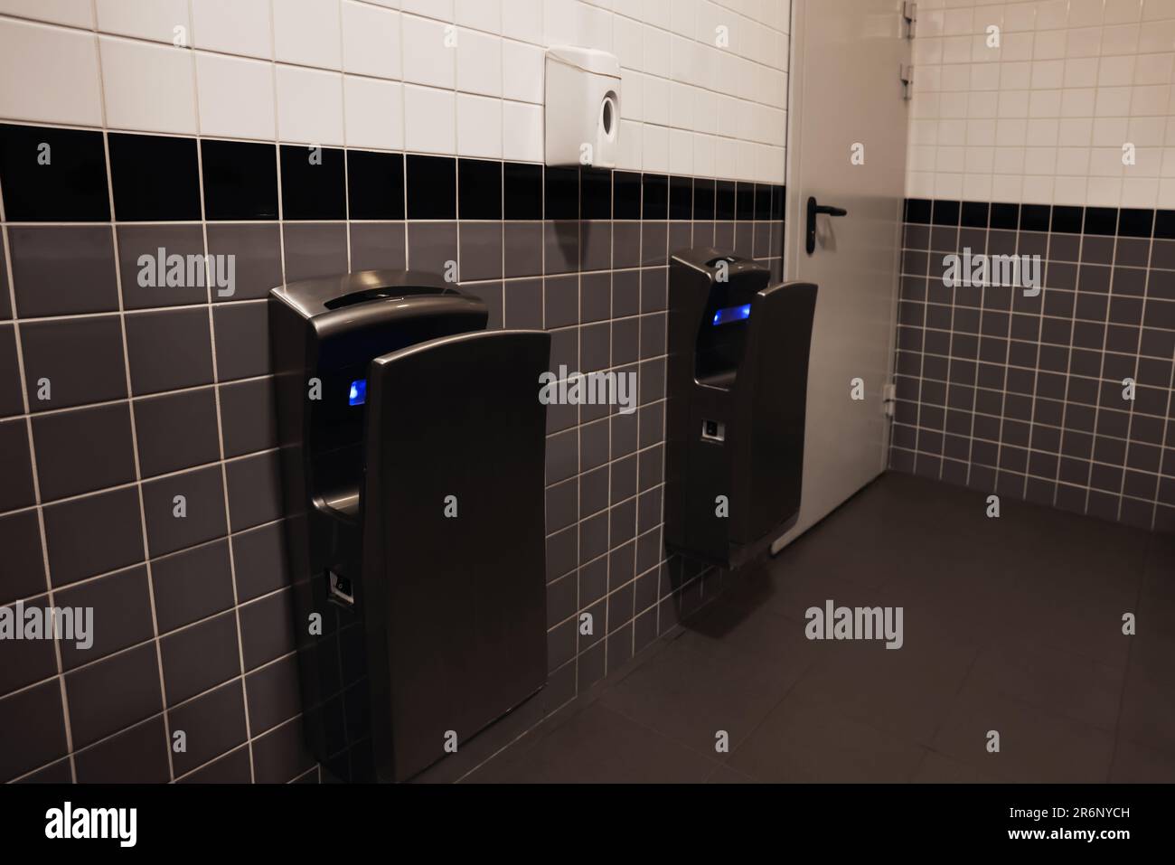 Modern hand dryers on tiled wall in public toilet Stock Photo Alamy