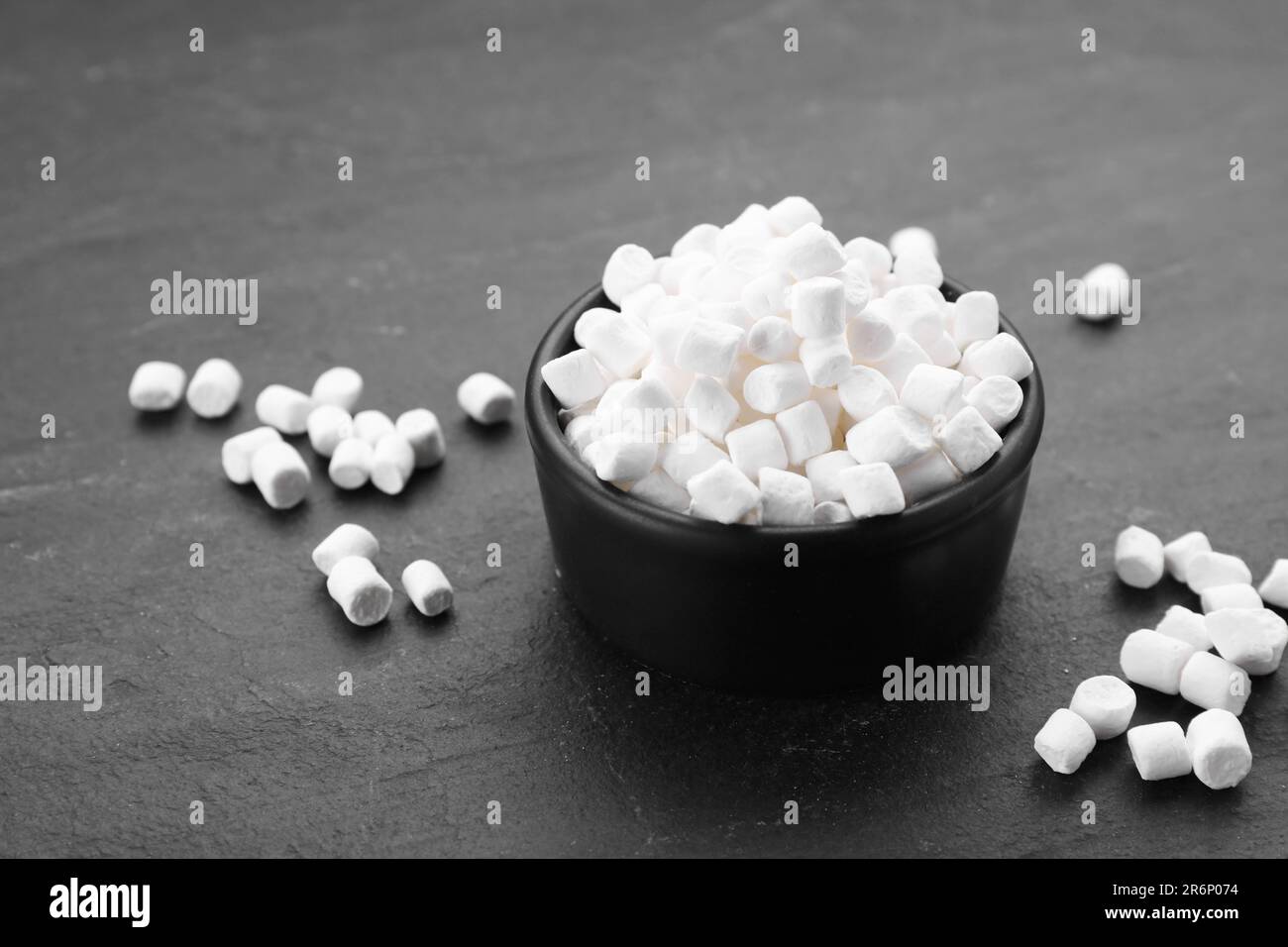 Bowl with delicious marshmallows on black background Stock Photo