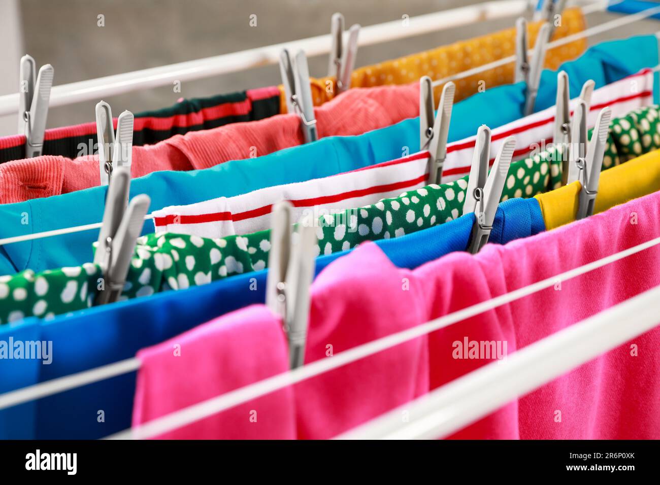 Clean laundry hanging on drying rack, closeup Stock Photo