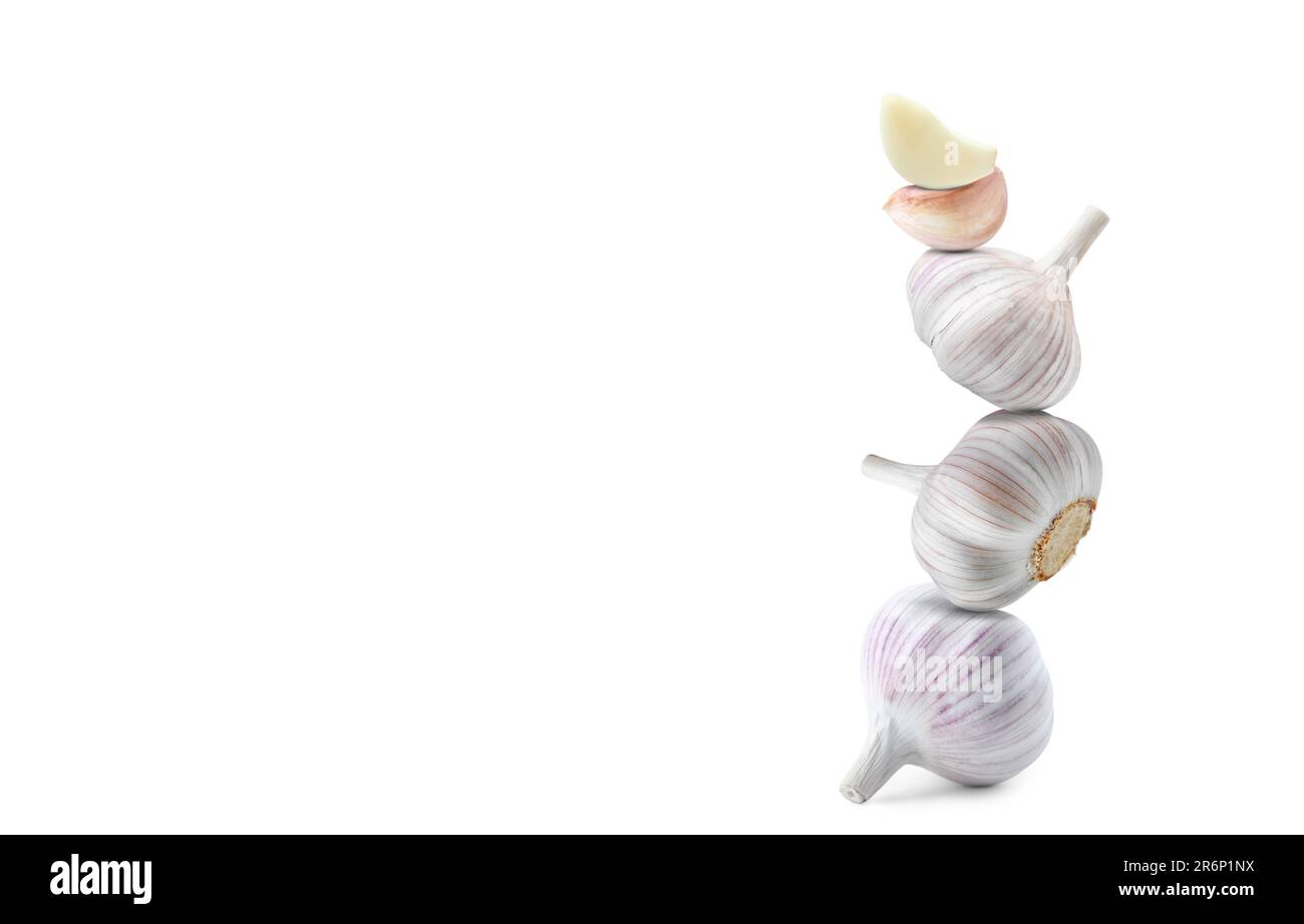 Stack of garlic bulbs and cloves on white background Stock Photo - Alamy