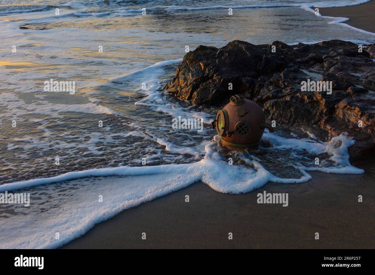Dive Helmet In Sea Foam On The Sonoma Coast Stock Photo