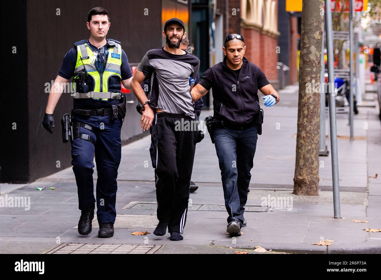 MELBOURNE, AUSTRALIA - MAY 28: A man is arrested for allegedly dealing drugs in the CBD on 28 May, 2020 in Melbourne, Australia. With international flights in and out of Australia almost entirely halted and stricter security measures due to COVID-19, experts are predicting a major decrease in the amount of illicit drugs entering Australia illegally. The side effect being that this may force many to turn to alternative drugs more available locally. Stock Photo