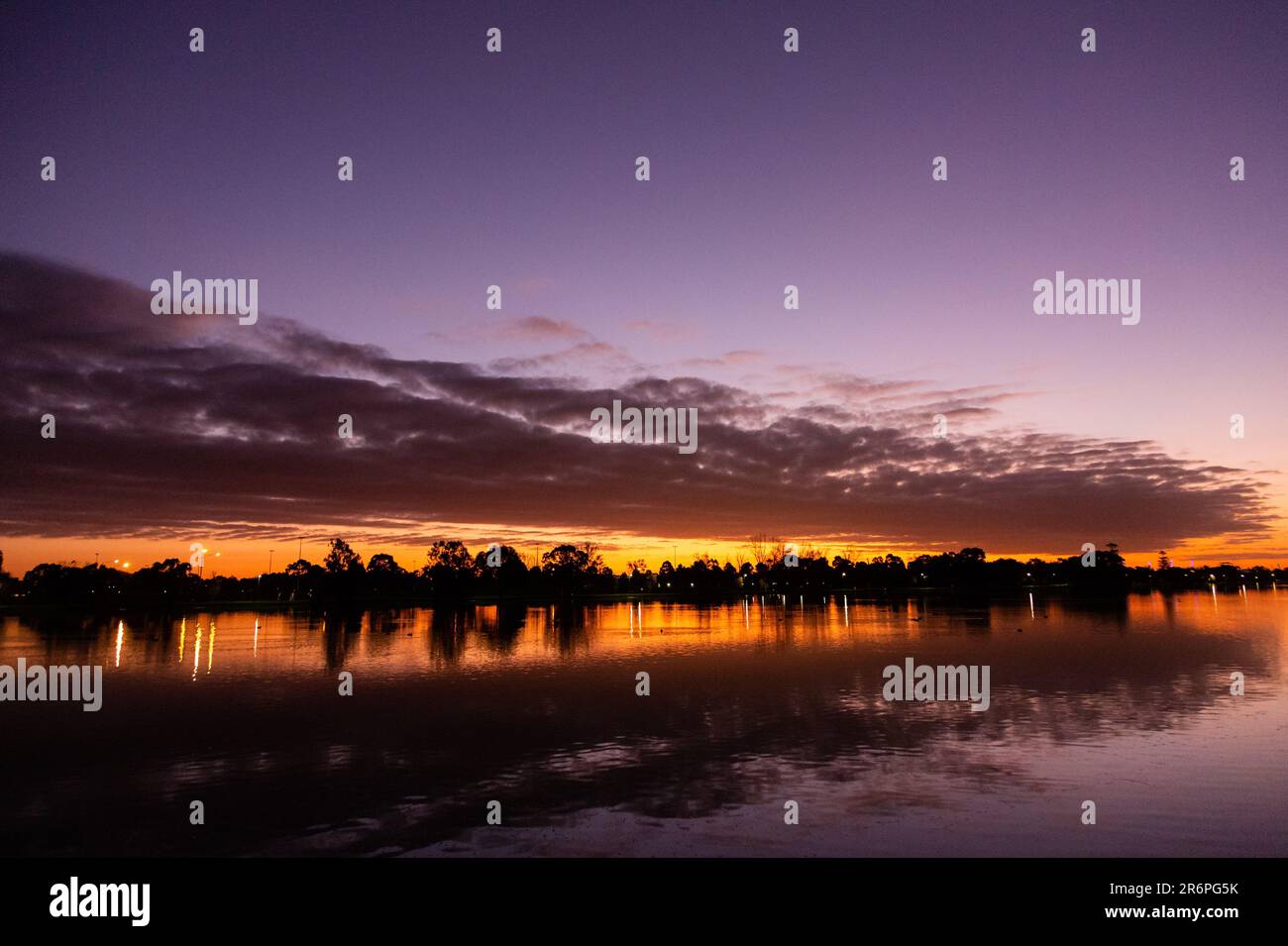 MELBOURNE, AUSTRALIA - APRIL 27: The sun sets behind Albert Park Lake during COVID 19 on 27 April, 2020 in Melbourne, Australia. Stock Photo