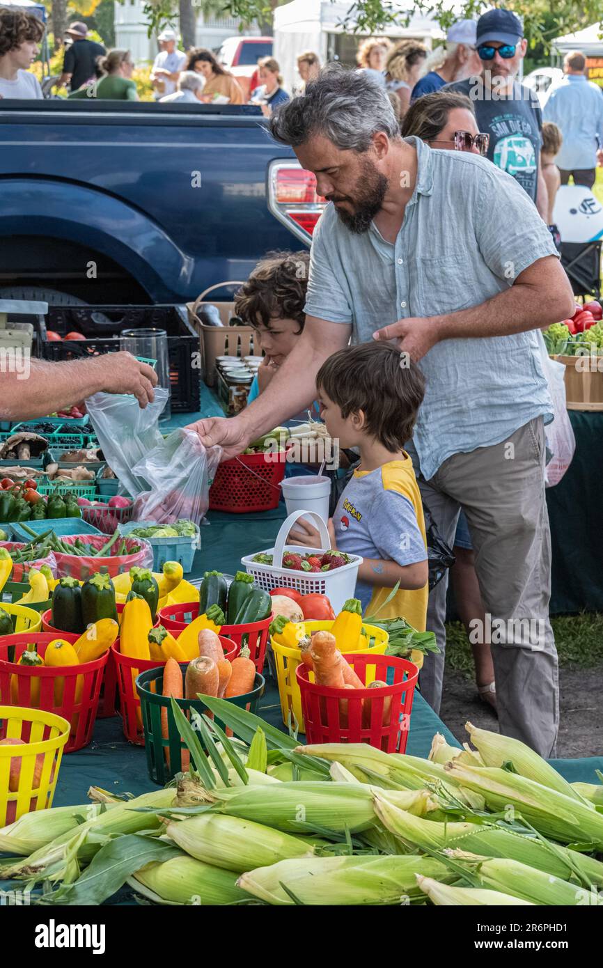 Father and sons purchasing farm fresh produce at the Tybee Island