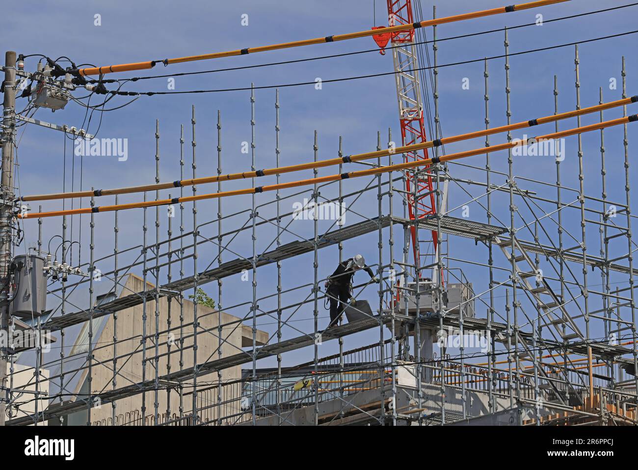 worker move on a scaffolding in the construction site of building near