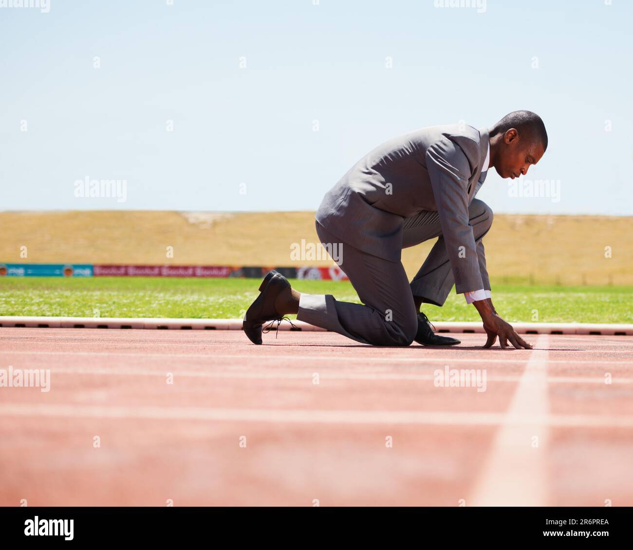 Start, race track and man in a suit for sport, running and fitness, cardio and speed practice. Starting line, ready and formal male sports runner at a Stock Photo