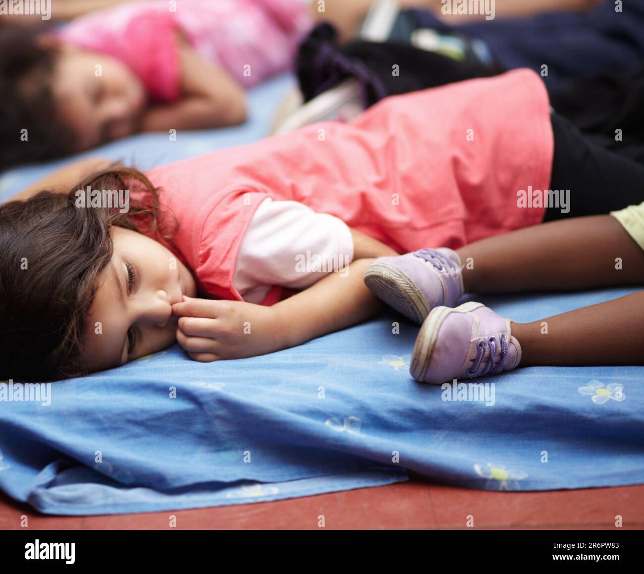 Kindergarten, children and group sleeping, relax and resting after education. Nursery, sleep and