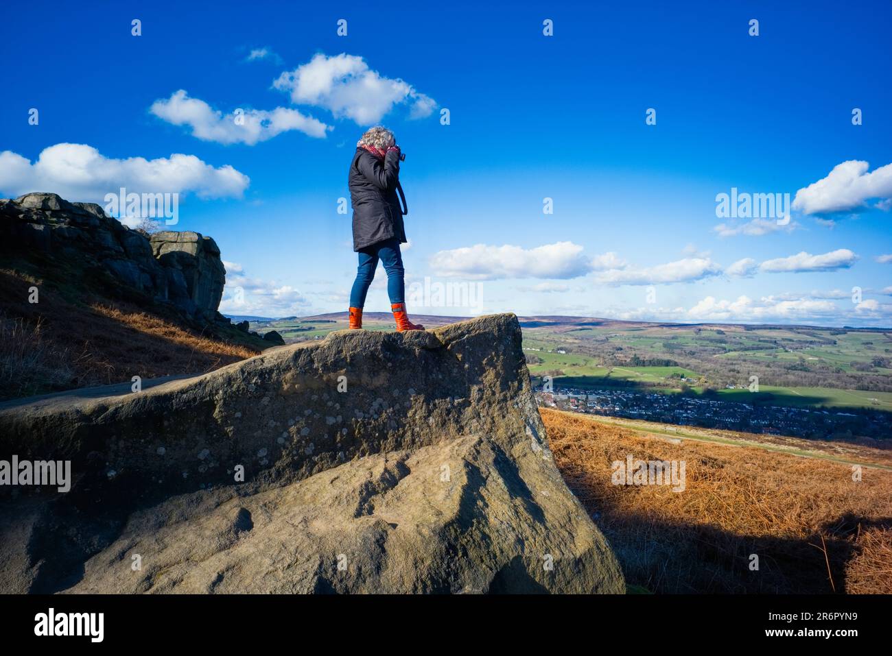 Film poet Janet Lees taking images at Cow and Calf rocks on Ilkley Moor Stock Photo