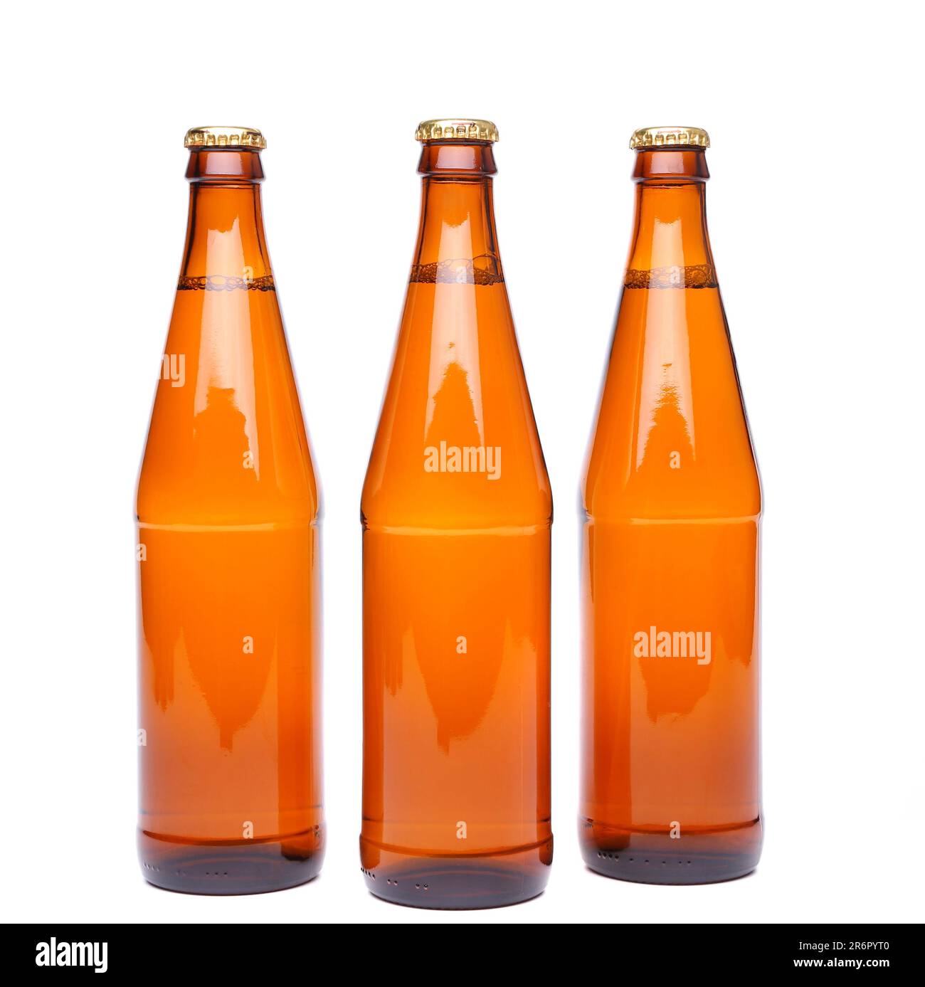 Three brown beer bottle with drops drink without label on a white