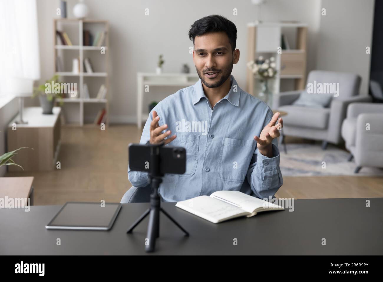 Positive young adult Indian guy shooting video on smartphone Stock Photo -  Alamy