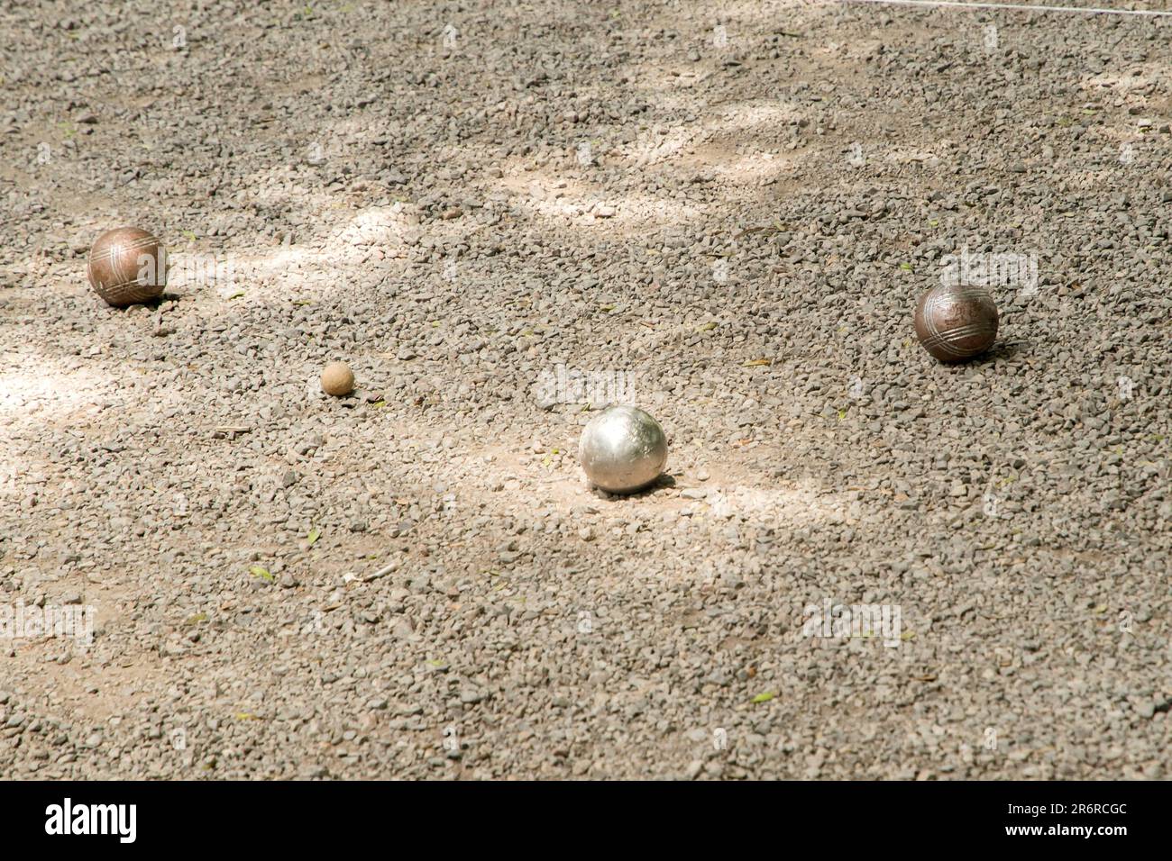 Petanque balls (boules) close to jack target ball on gravel petanque