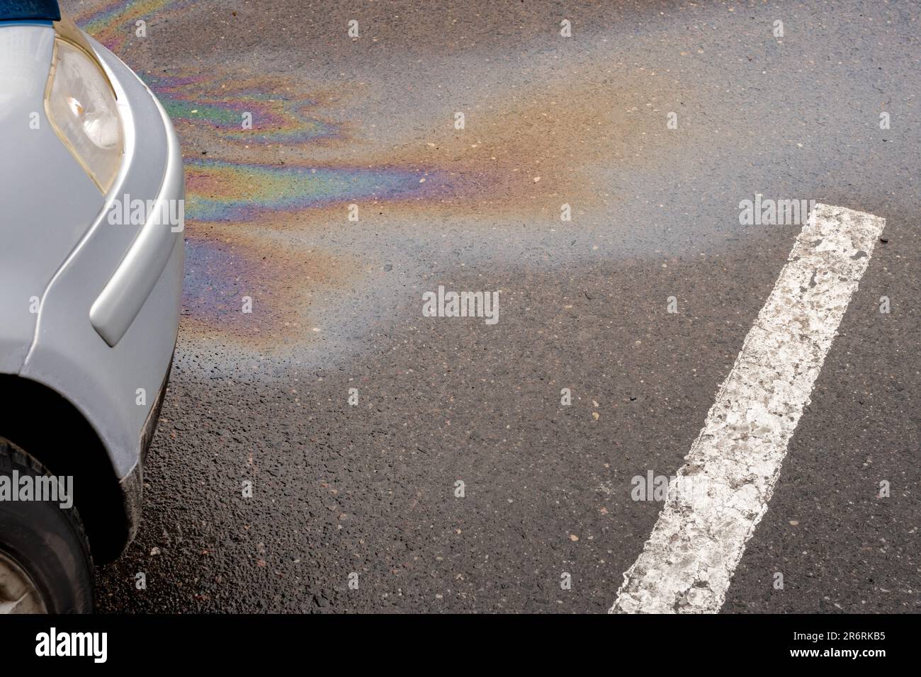 Oil stain or gasoline caused by a leak under a car. Environmental