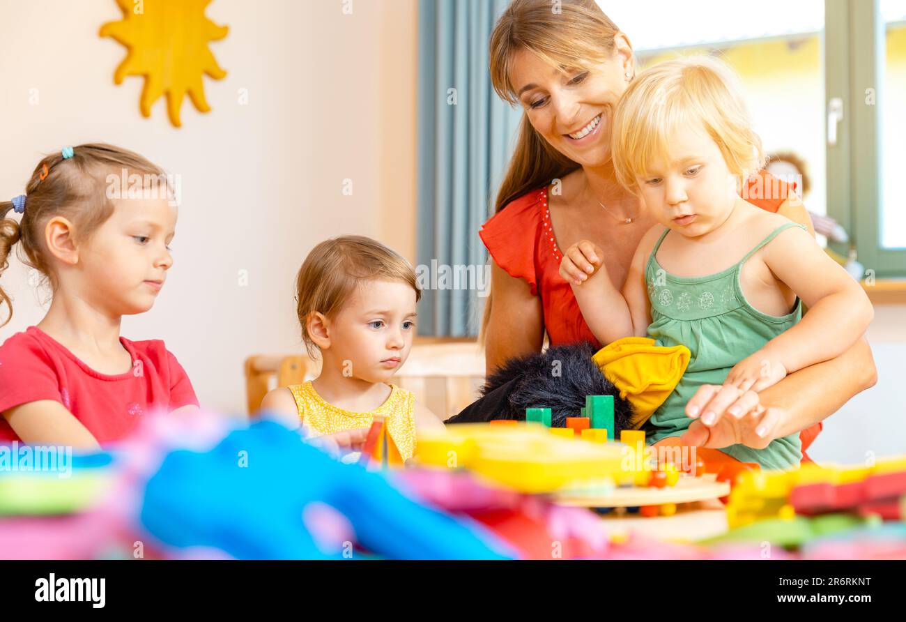 Play school teacher with her students Stock Photo