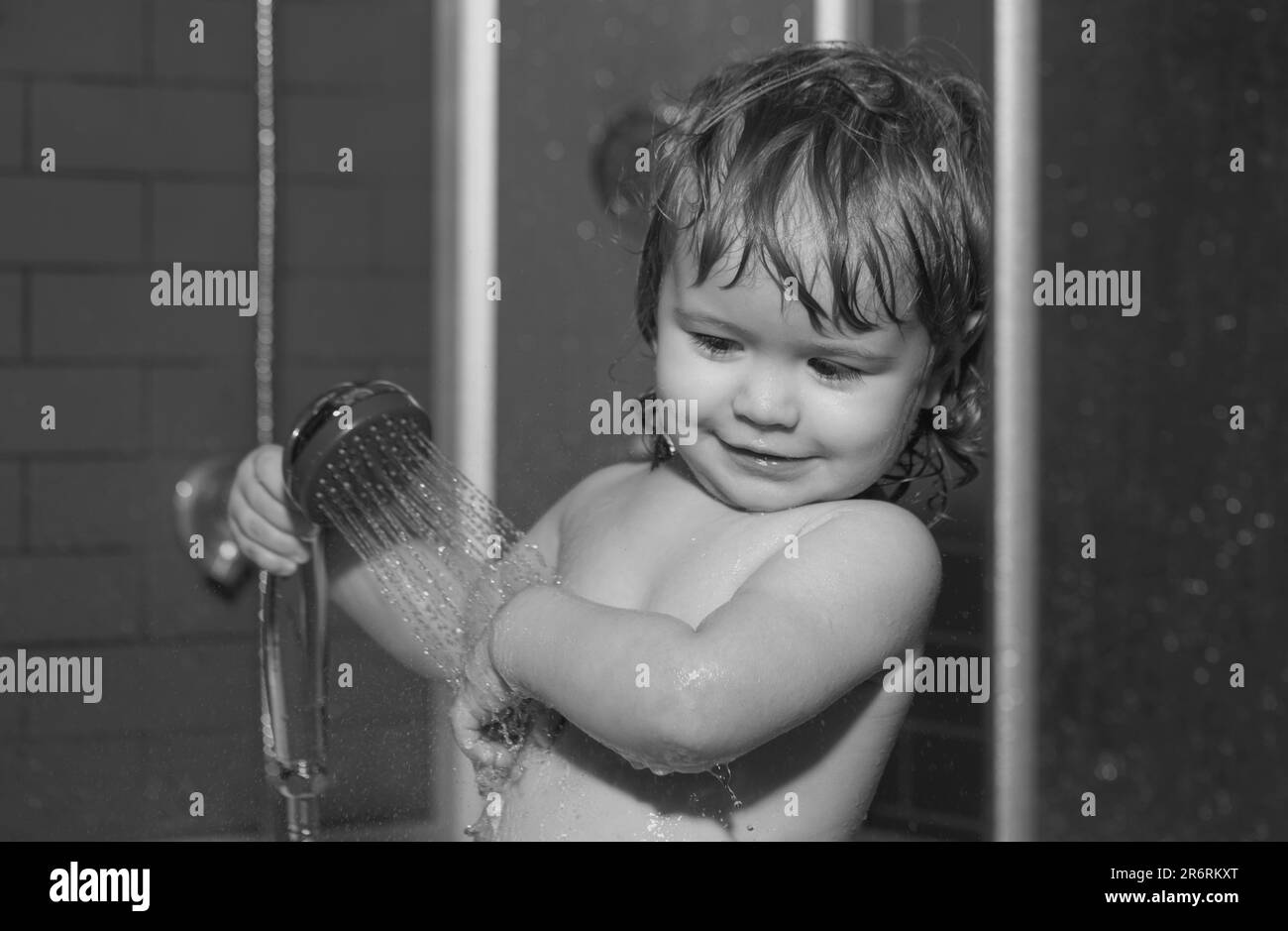 Child having fun to bath. Baby showering. Portrait of kid bathing in a