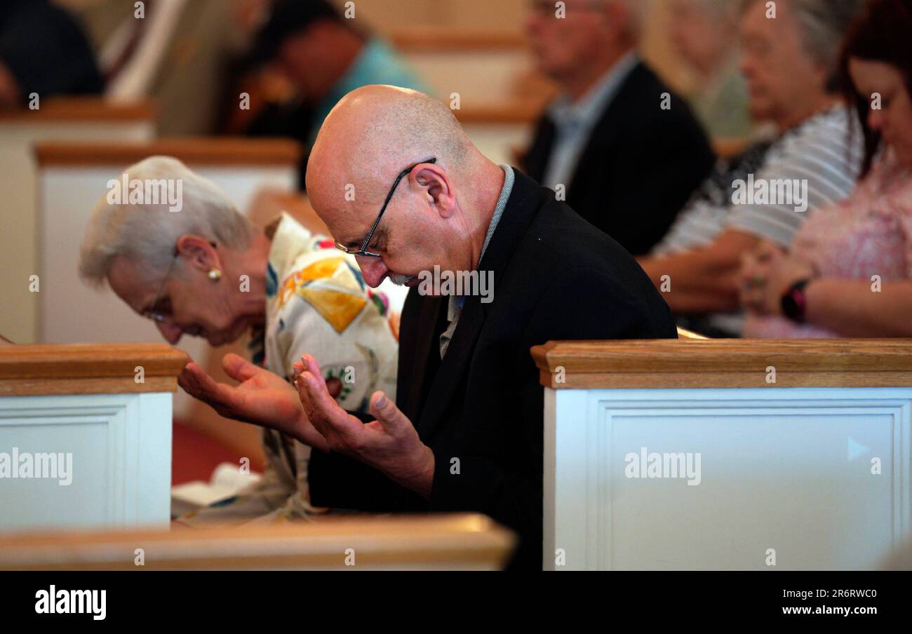 Members of Fern Creek Baptist Church pray during a service, Sunday, May