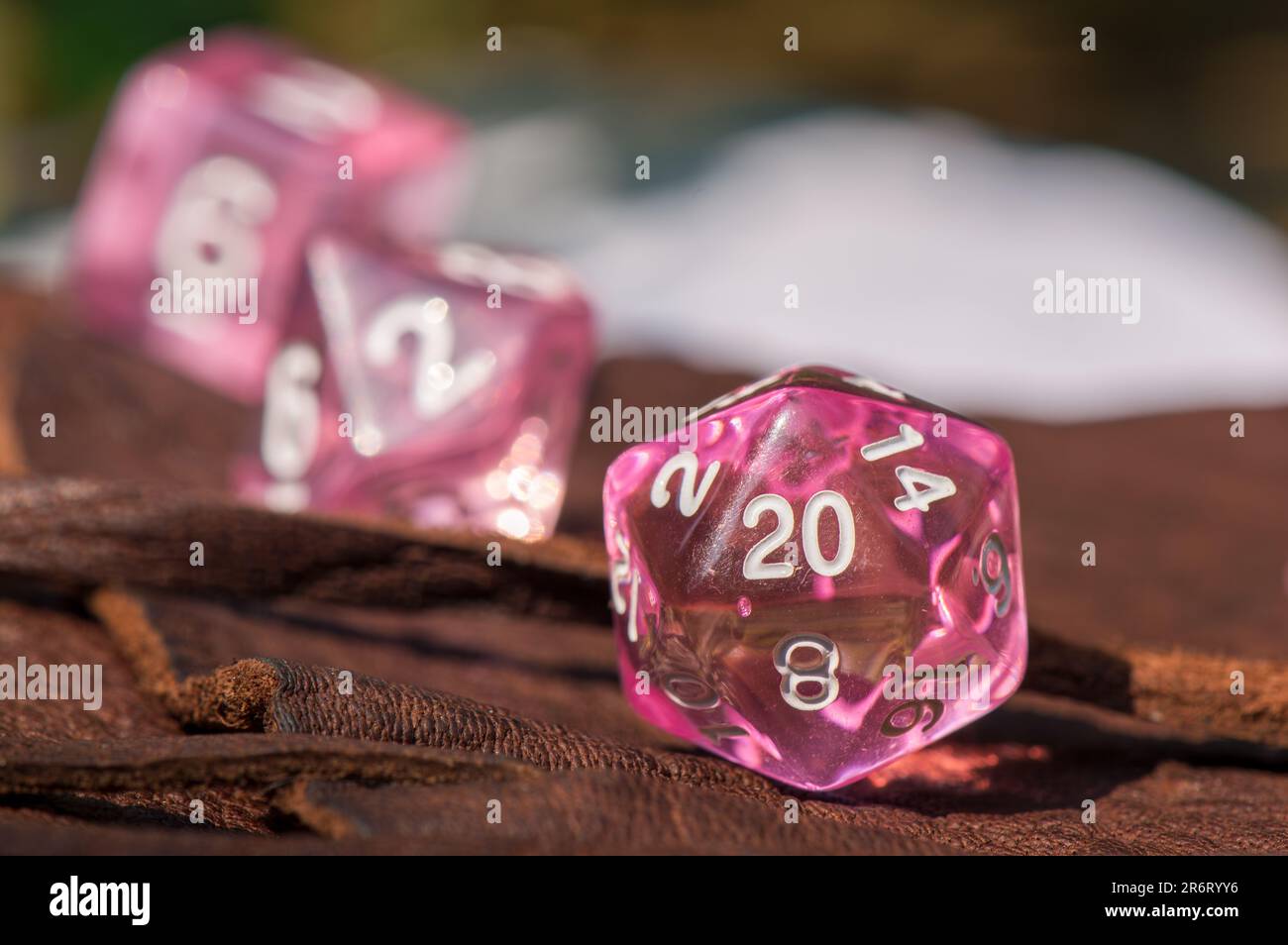 Macro image of a transparent pink 20-sided role-playing gaming die Stock Photo