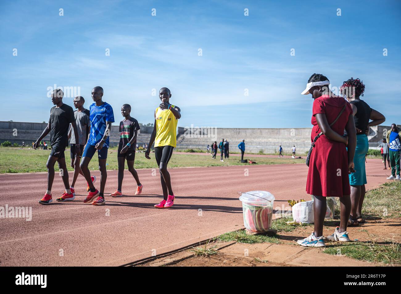 (230611) -- ITEN, June 11, 2023 (Xinhua) -- Kenyan runner Kelvin Kimtai Chepsigor (5th L) from Kisii University gestures during a training session in Eldoret, Kenya, on June 6, 2023. At nearly 6 am, the first morning light shines upon the landmark arch written with 'Home of Champions' in Iten, the runners gathered here to greet each other with a fist bump, stretch their muscles, and prepare for the first training session of the day. With an average altitude of 2,400 meters, Iten sits in the west of Kenya, near the Great Rift Valley of East Africa. It is an ideal long-distance running training Stock Photo