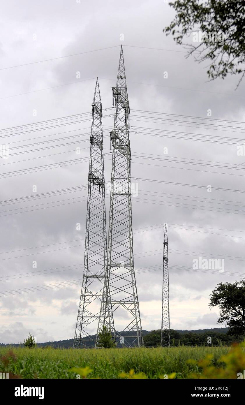 Power pylons, power pylons in the field, power lines, overhead power line, supply lines, electrosmog, environmental pollution, high voltage, power Stock Photo