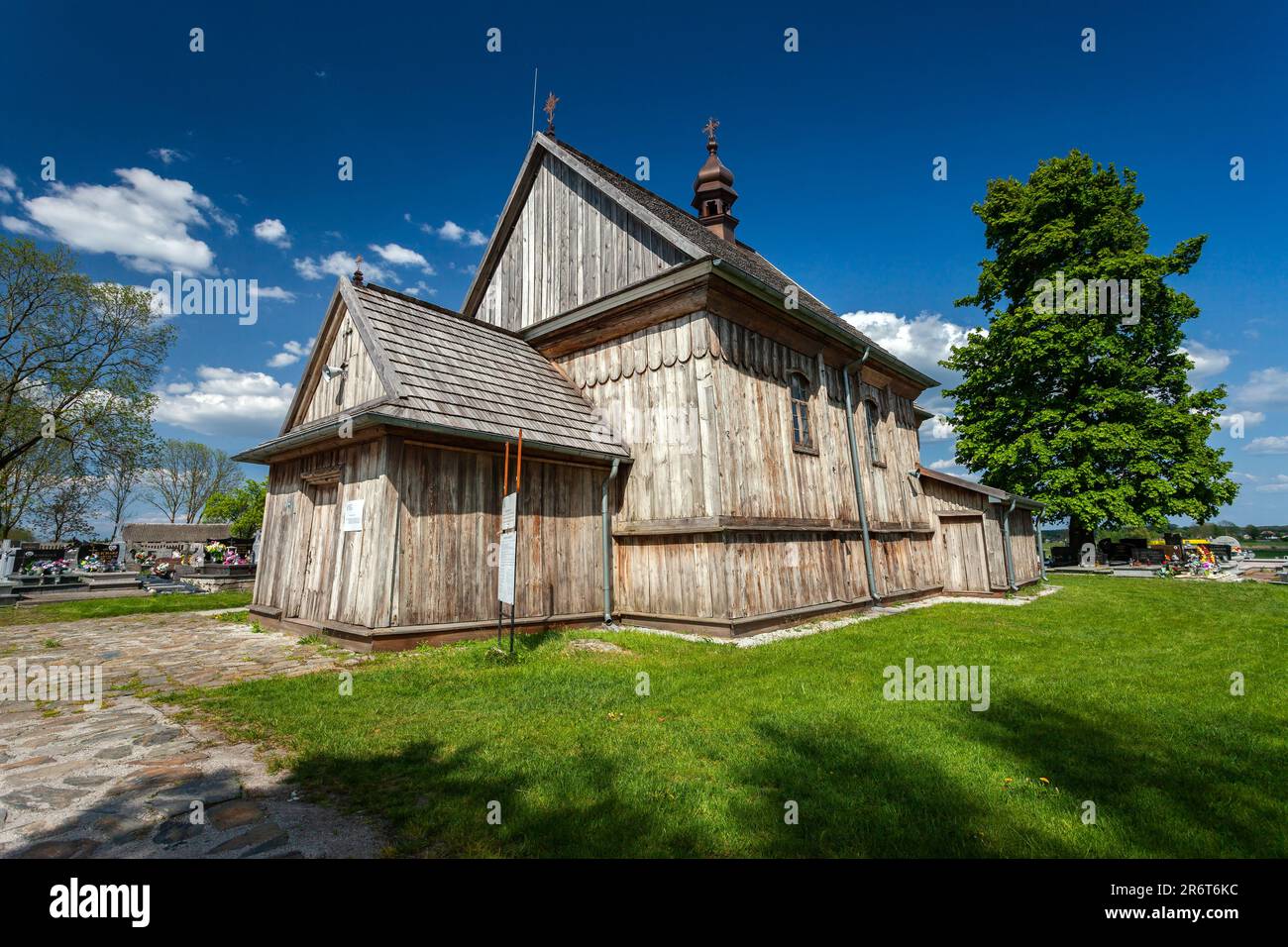 Przysiolek, Lubelskie, Poland - May 14, 2023: Historic wooden Roman Catholic Church from 1746 in sunny day Stock Photo