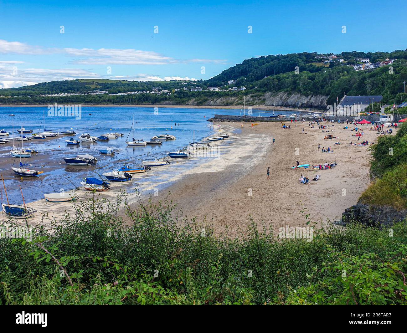 boats ashore along the sandy beach at New Quay, Ceredigion, West Wales,Cymru UK Stock Photo