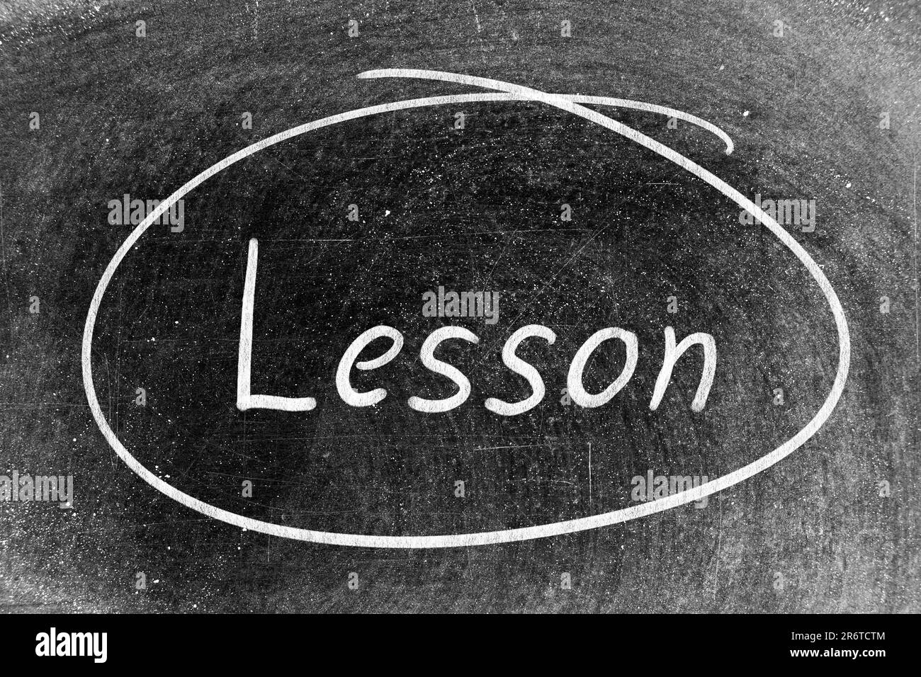 White chalk hand writing in word lesson and circle shape on blackboard background Stock Photo