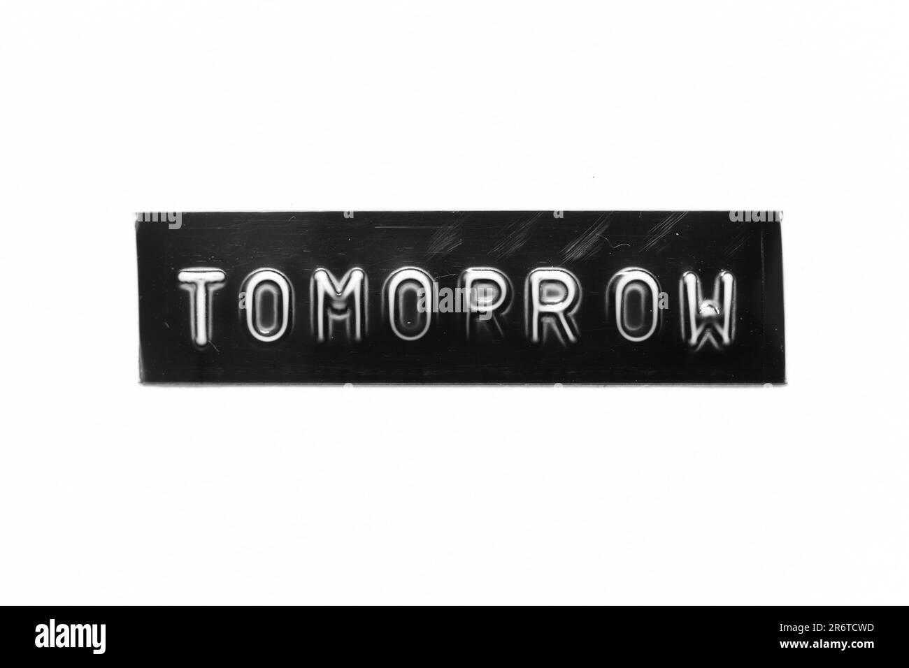 Black color banner that have embossed letter with word tomorrow on white paper background Stock Photo
