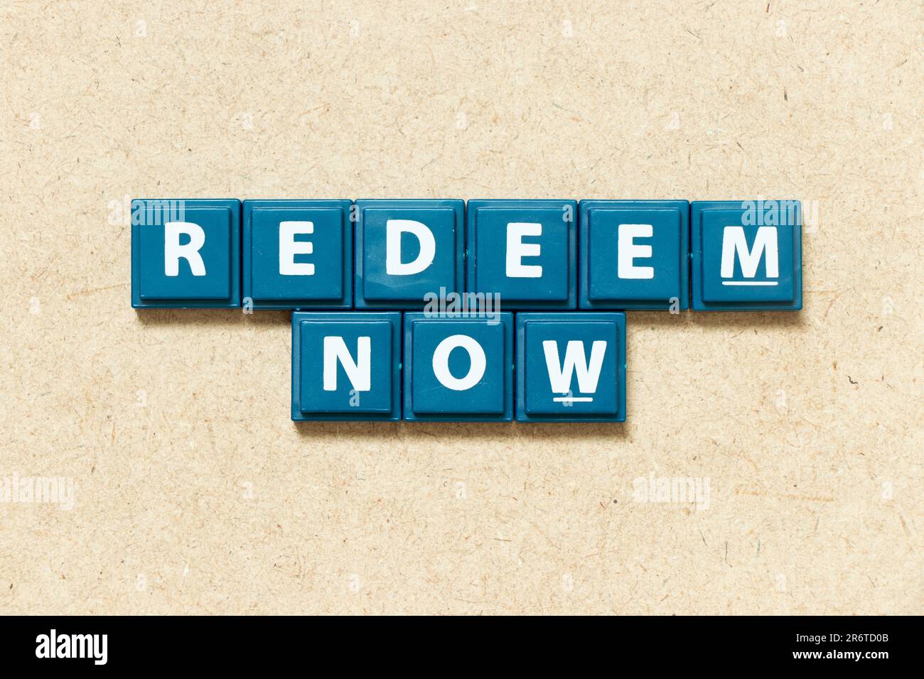 Tile alphabet letter in word redeem now on wood background Stock Photo