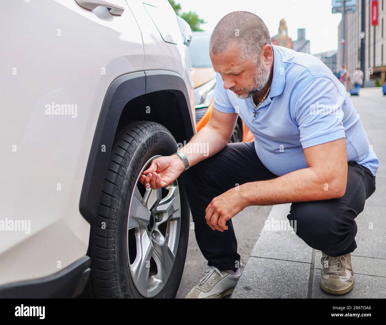 A man changes the wheel of a car. Wheel repair and replacement on a car