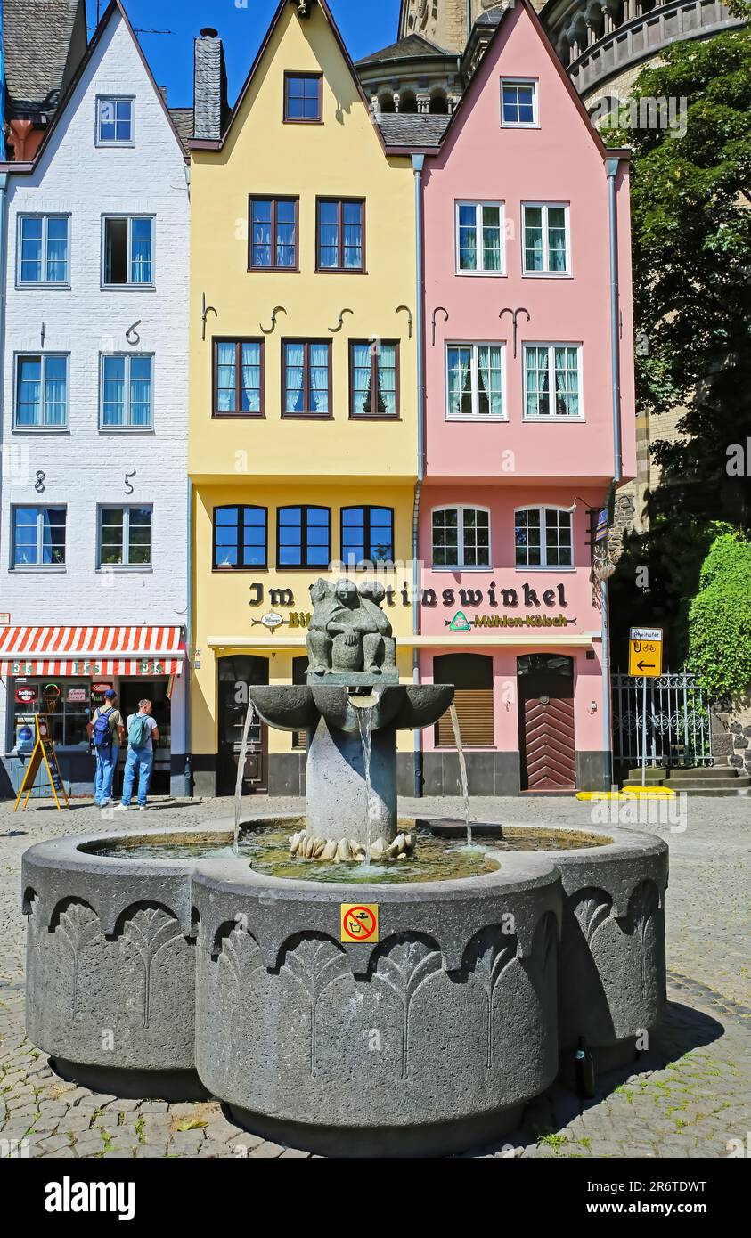 Cologne (Köln, Fischmarkt), Germany - June 6. 2023: Square with fountain in old city center, colorful medieval tall houses Stock Photo