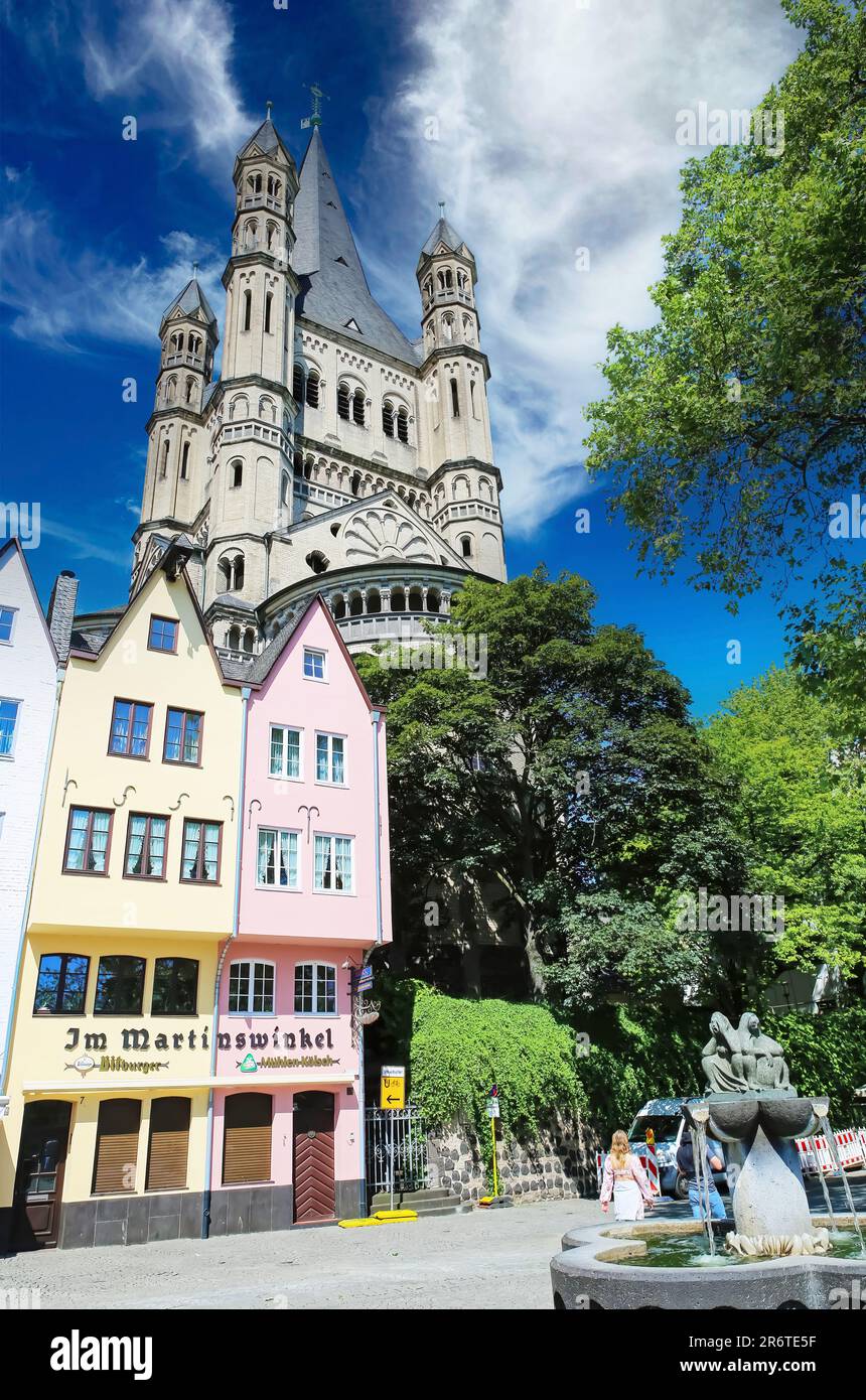 Cologne (Köln, Fischmarkt), Germany - June 6. 2023: Beautiful old square, Fischweiber fountain, St. Martin church, colorful houses Stock Photo