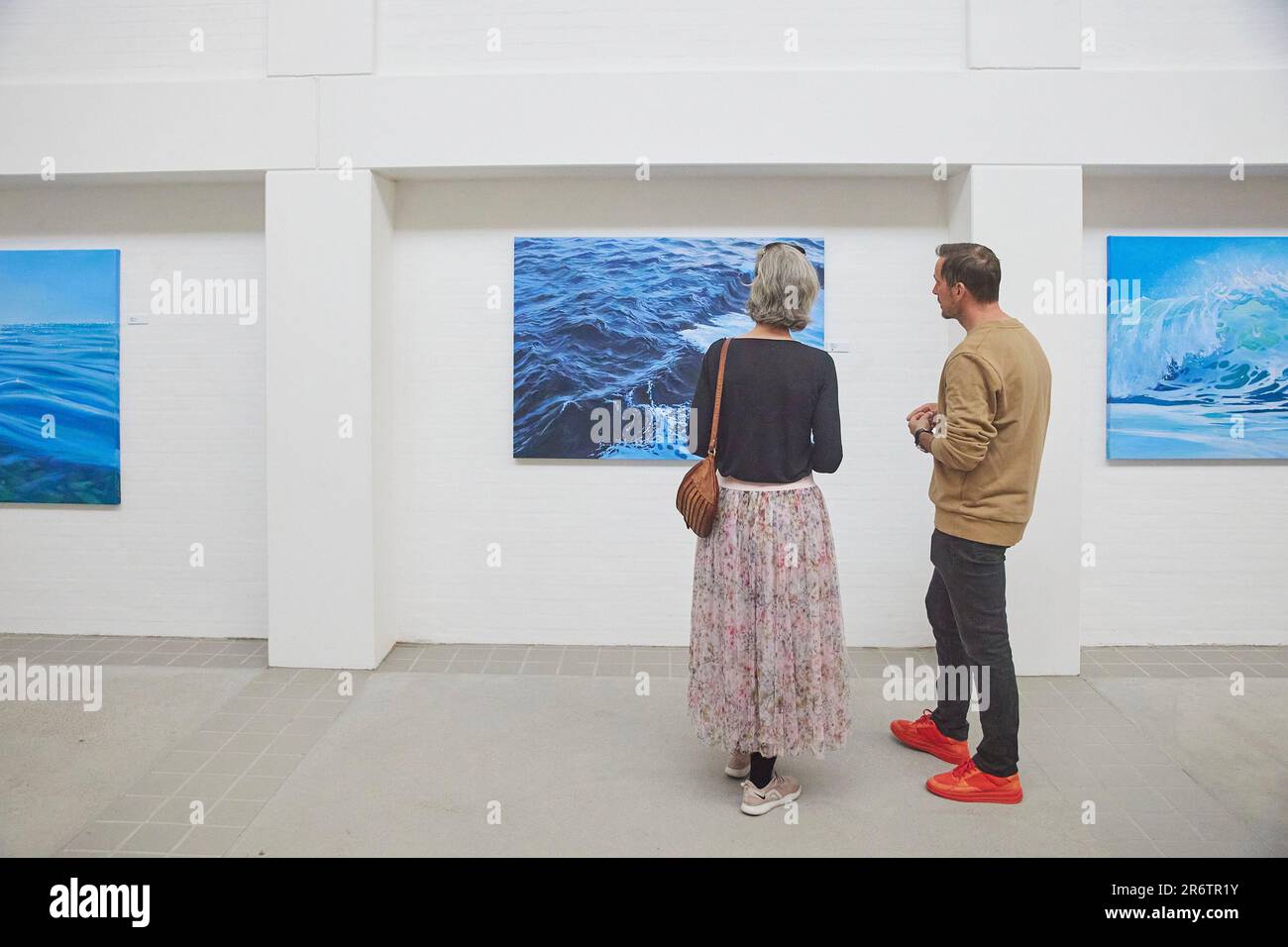 Skagen, Denmark, May, 2023: Visitors look at the paintings in gallery