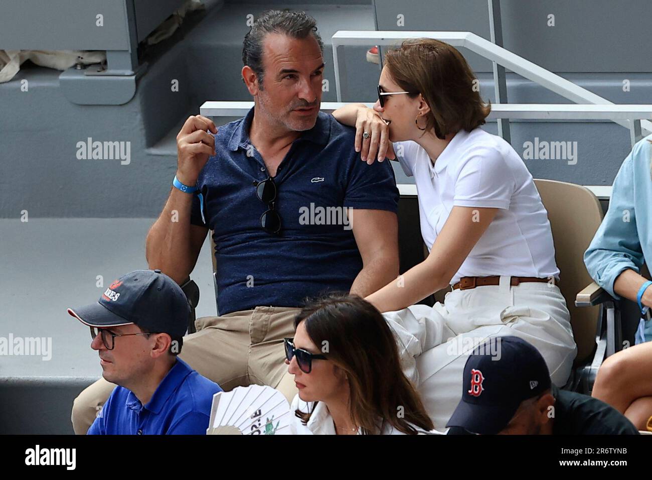 French actor Jean Dujardin, top left, and his wife Nathalie Pechalat, next to him, watch the final match of the French Open tennis tournament between Serbias Novak Djokovic and Norways Casper Ruud