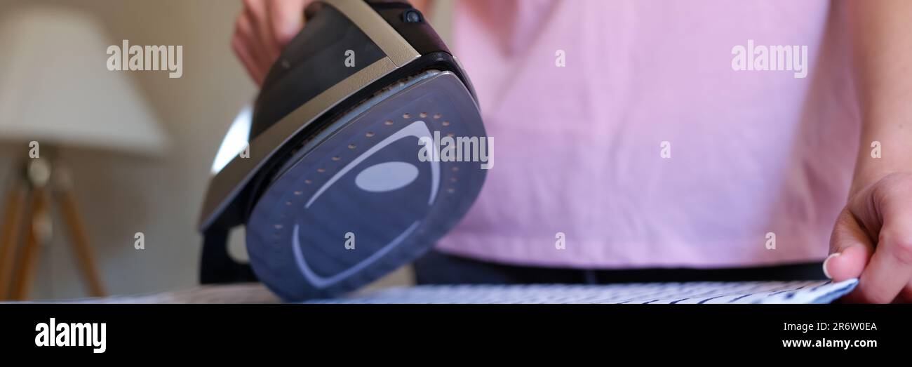 Woman housewife ironing bed linen using steam iron Stock Photo Alamy