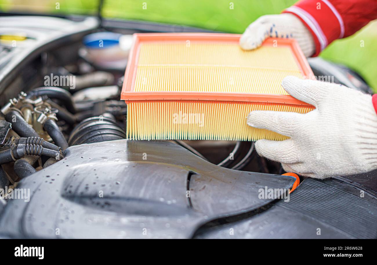 Change the filter on the car engine during vehicle maintenance. Stock Photo