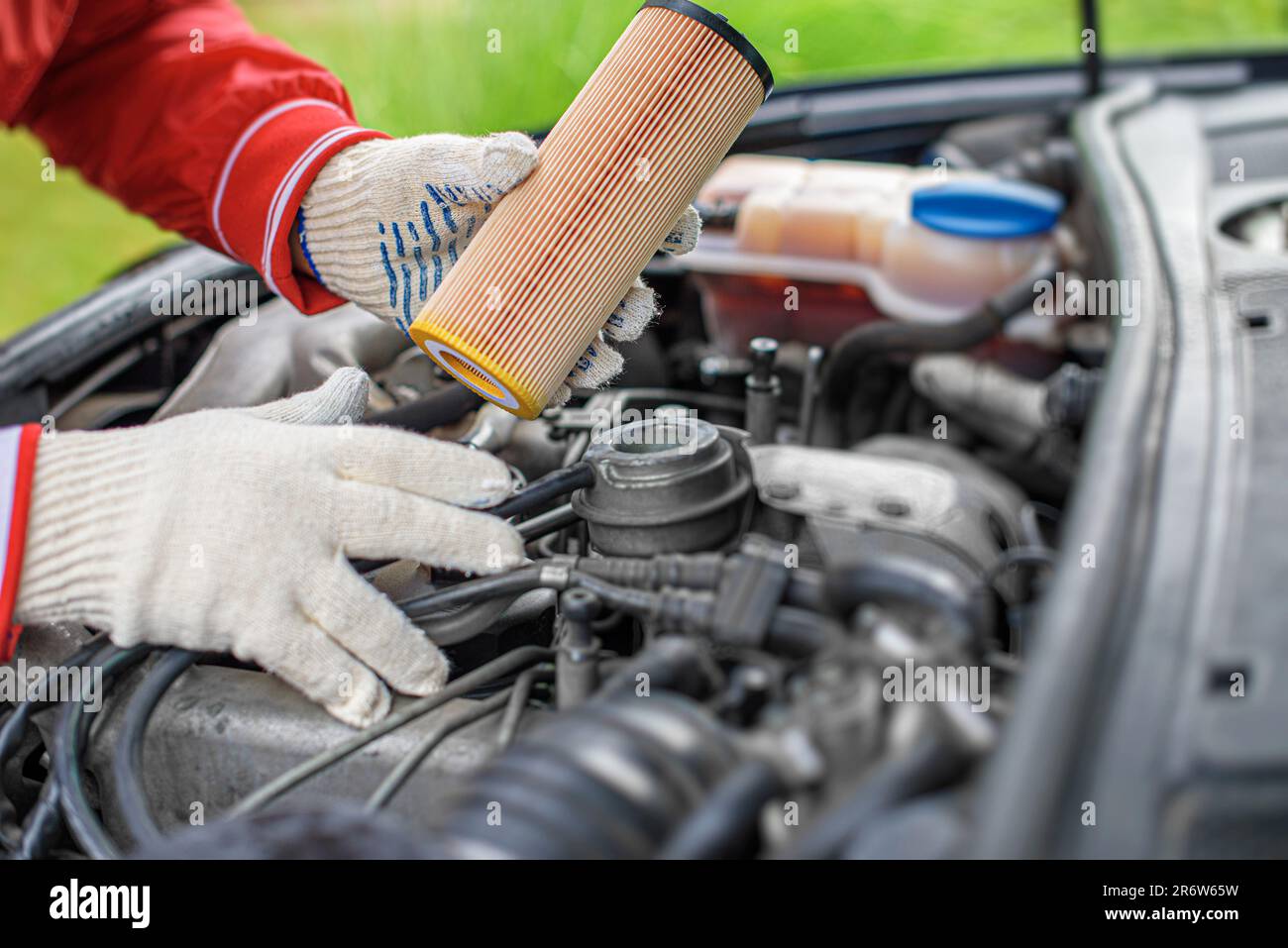 Change the filter on the car engine during vehicle maintenance. Stock Photo