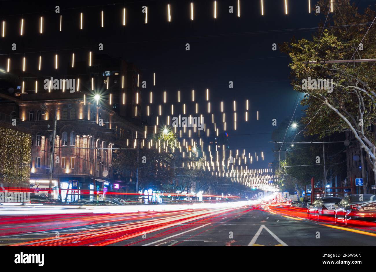 An aerial view of a bustling cityscape at night, illuminated by the ...
