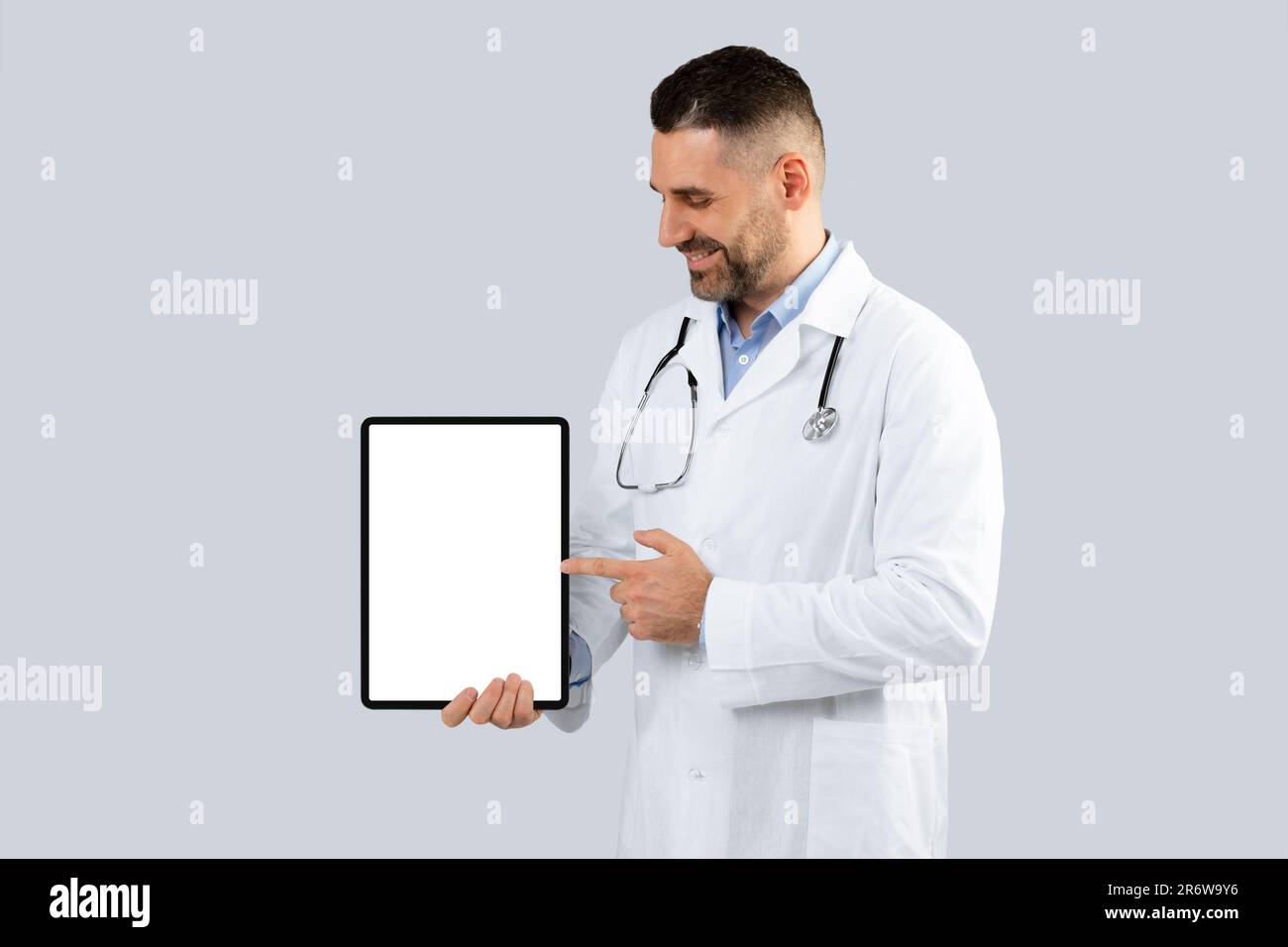 Great medical mebsite. Doctor man pointing at digital tablet with blank ...