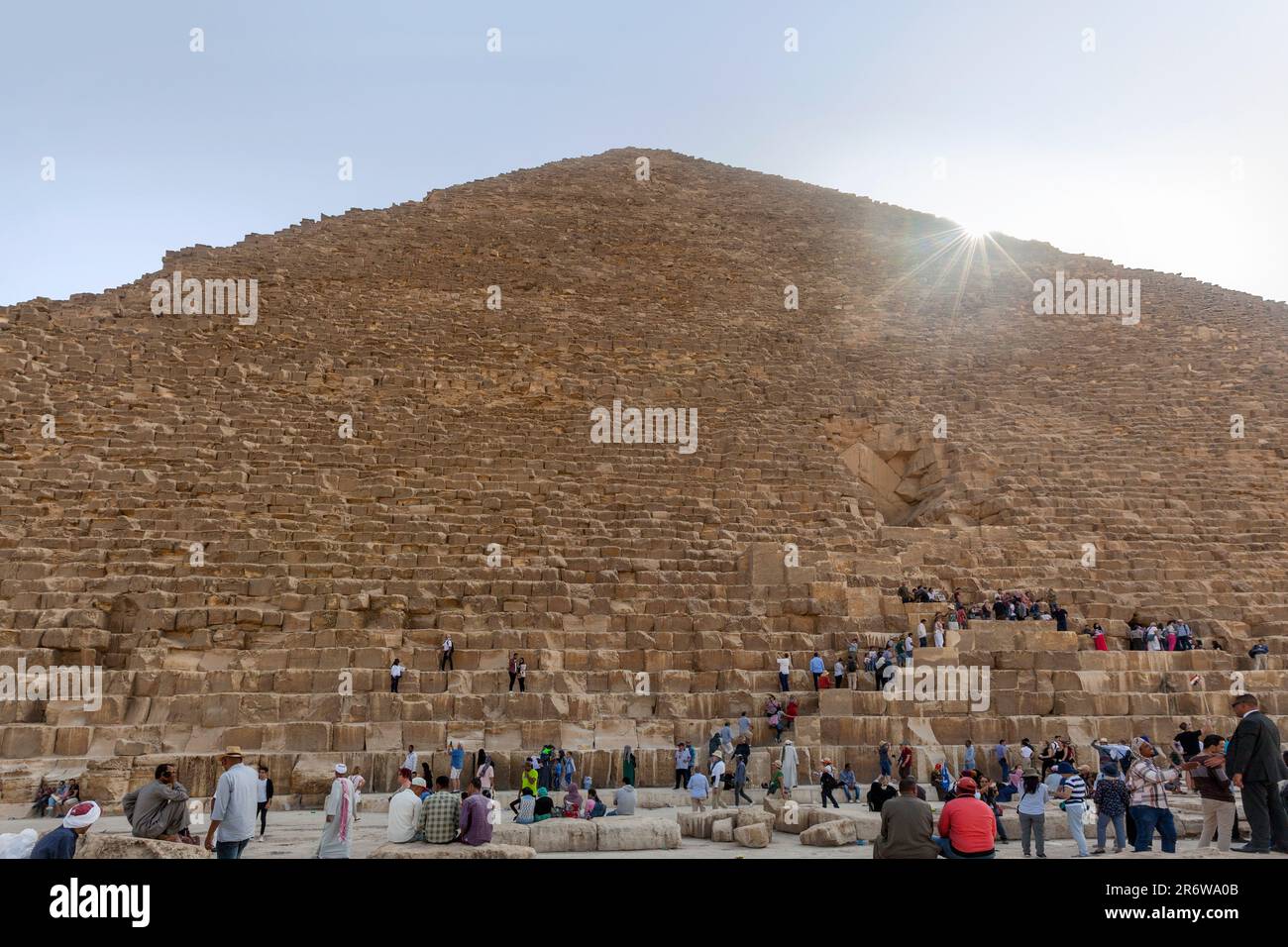 Tourists climbing the steps of the Pyramid of Khufu at Giza in Cairo