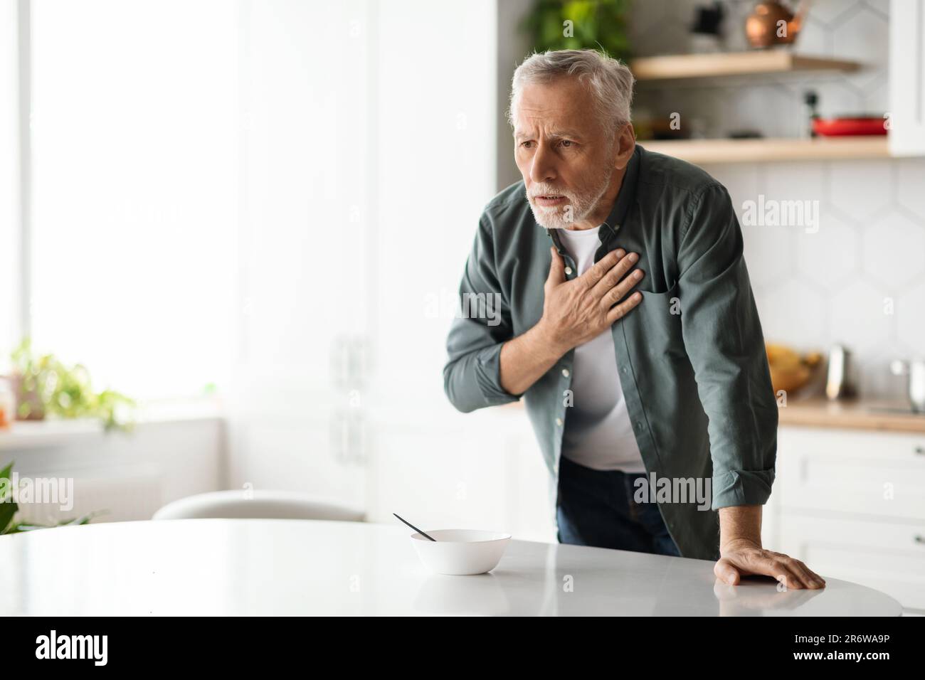 Heart Attack. Senior man suffering from chest pain at home Stock Photo ...