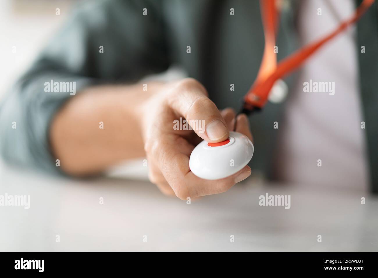 Unrecognizable senior man pushing panic button on emergency equipment Stock Photo