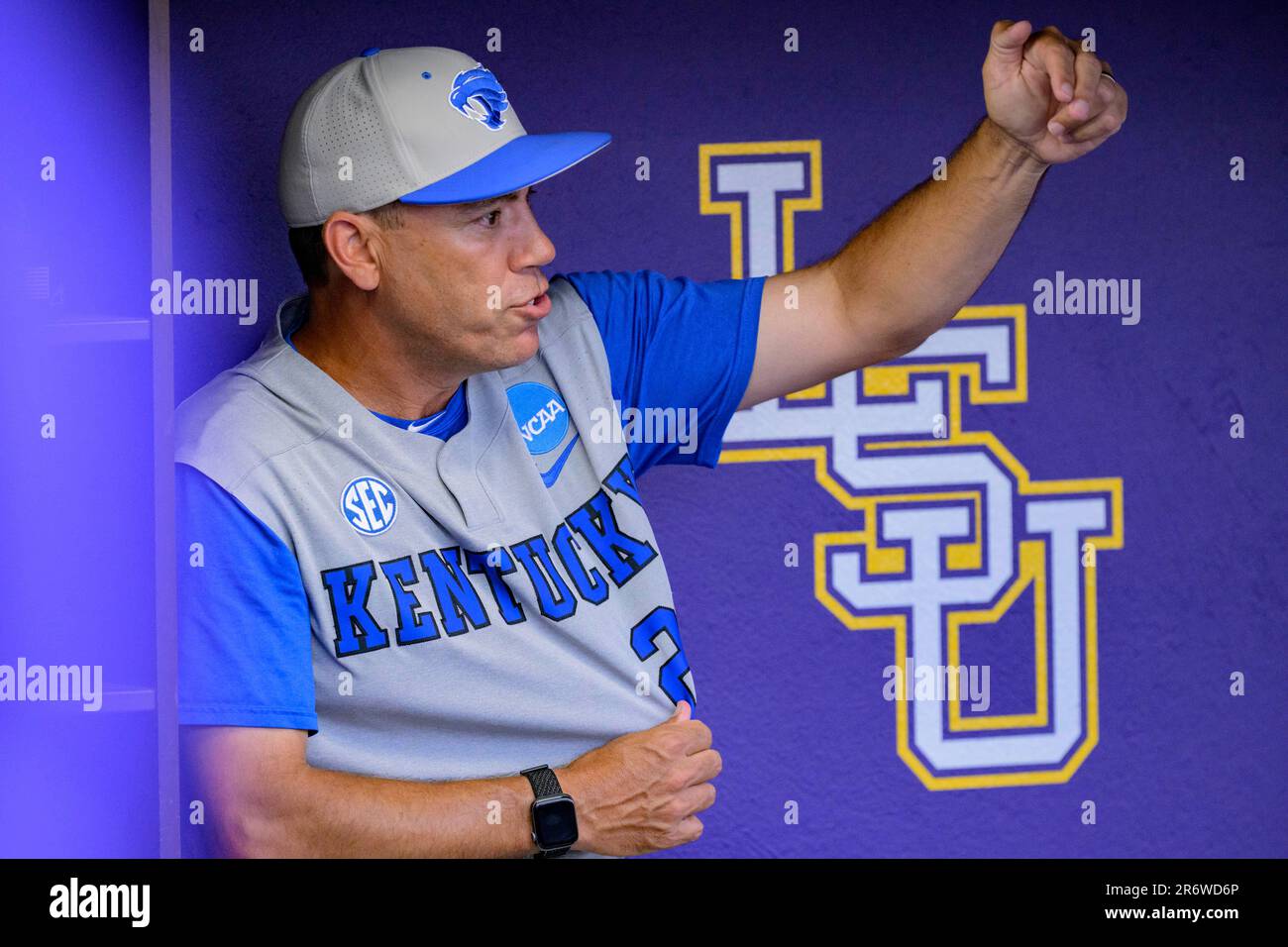 Kentucky head coach Nick Mingione talks in the dugout before an NCAA