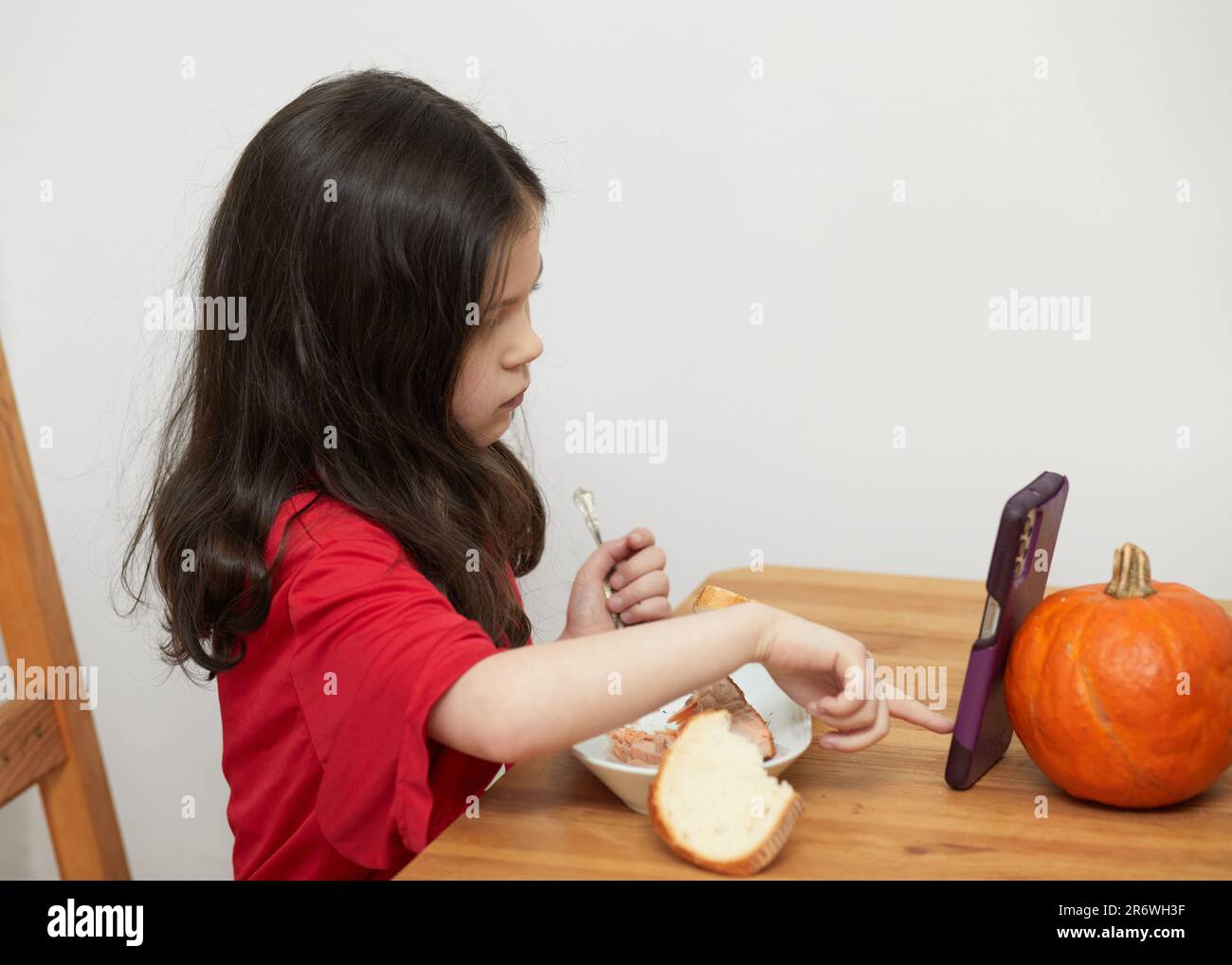 Cute Young Girl With A Missing Primary Tooth Is Talking While Eating A Cute young girl with a missing primary tooth is talking while eating a