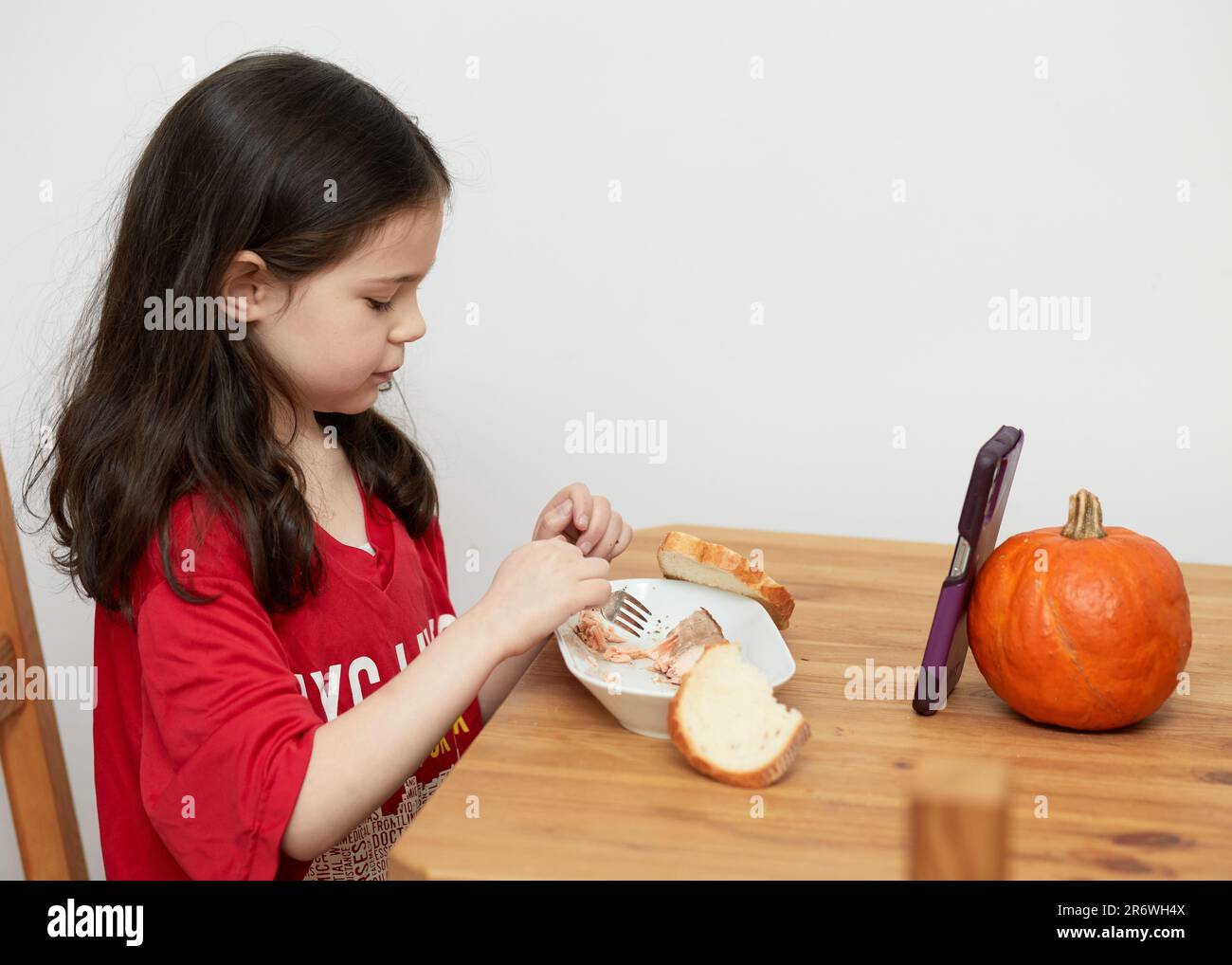 Cute Young Girl With A Missing Primary Tooth Is Talking While Eating A Cute young girl with a missing primary tooth is talking while eating a