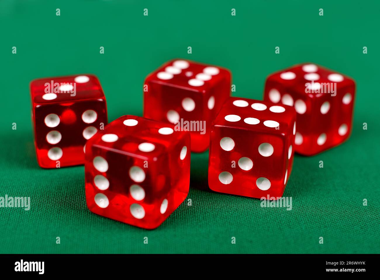 red dice on green table, close up Stock Photo