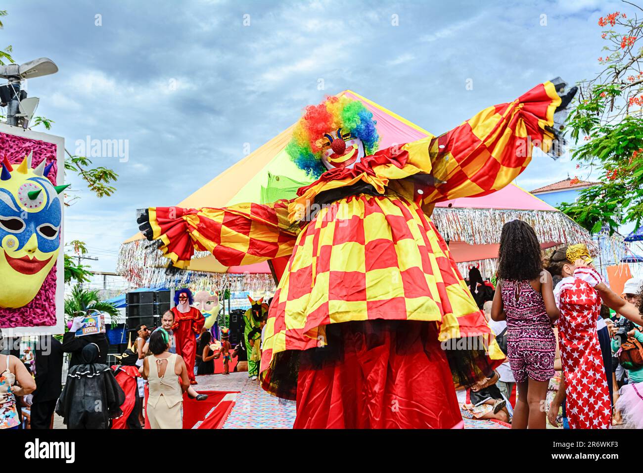 A clown wearing brightly-colored red and yellow costume during a ...