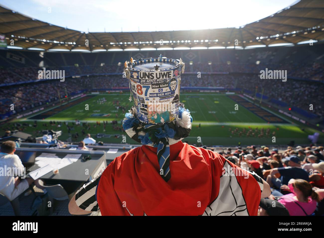 Hamburg, Germany. 11th June, 2023. American football: professional league ELF, main round, main round games, 2nd matchday, Hamburg Sea Devils - Rhein Fire, at Volksparkstadion. A fan with HSV and Uwe Seeler stickers on his top hat is standing in the stands. Credit: Marcus Brandt/dpa/Alamy Live News Stock Photo