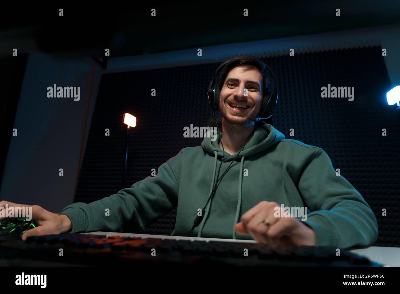 Happy cybersport gamer playing video game in dark room Stock Photo - Alamy