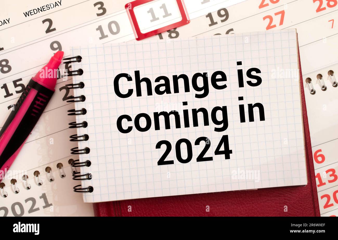 CHANGE COMING IN 2025. red and black font on white paper on the table
