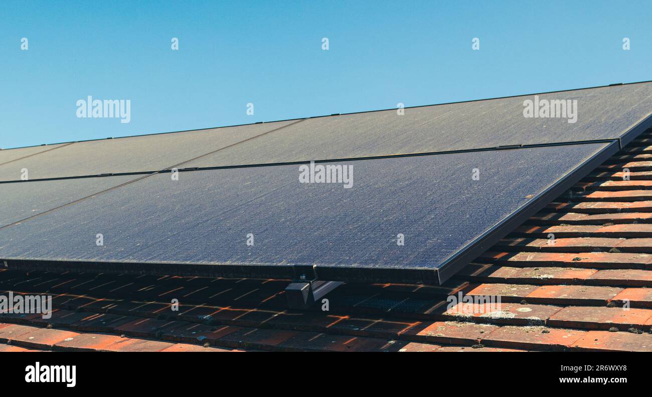 Solar panels on roof covered with dust during dry summer month. Stock Photo