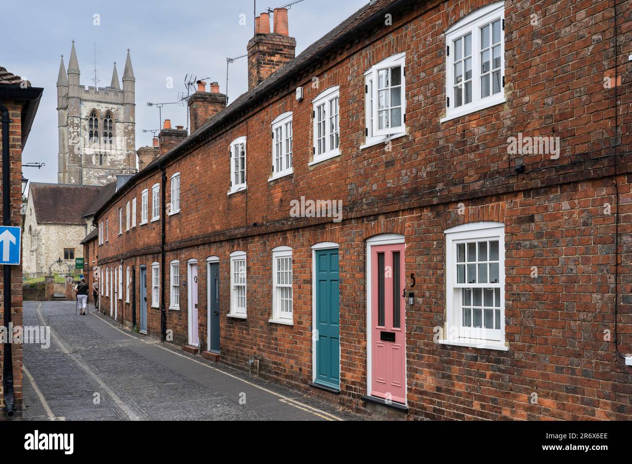 Listed terraced red brick cottages with colourful doors on Lower Church Lane in the picturesque market town of Farnham in Sussex, England Stock Photo